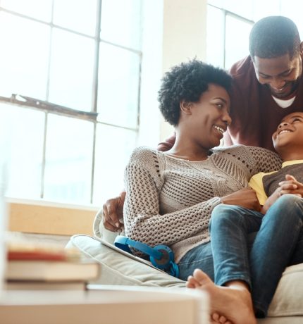 Black,Family,,Happy,And,Relax,On,Sofa,With,Boy,And