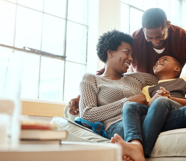 Black,Family,,Happy,And,Relax,On,Sofa,With,Boy,And