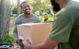 Black,Man,,Volunteering,And,Giving,Box,In,Park,Of,Donation,
